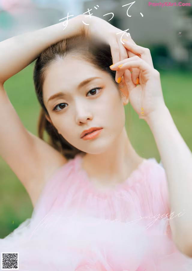 A woman in a pink dress posing for a magazine.