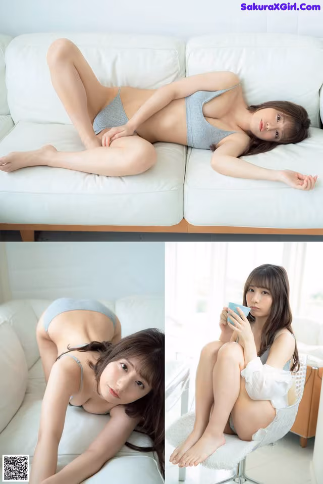 A woman laying on a white couch holding a cup of coffee.