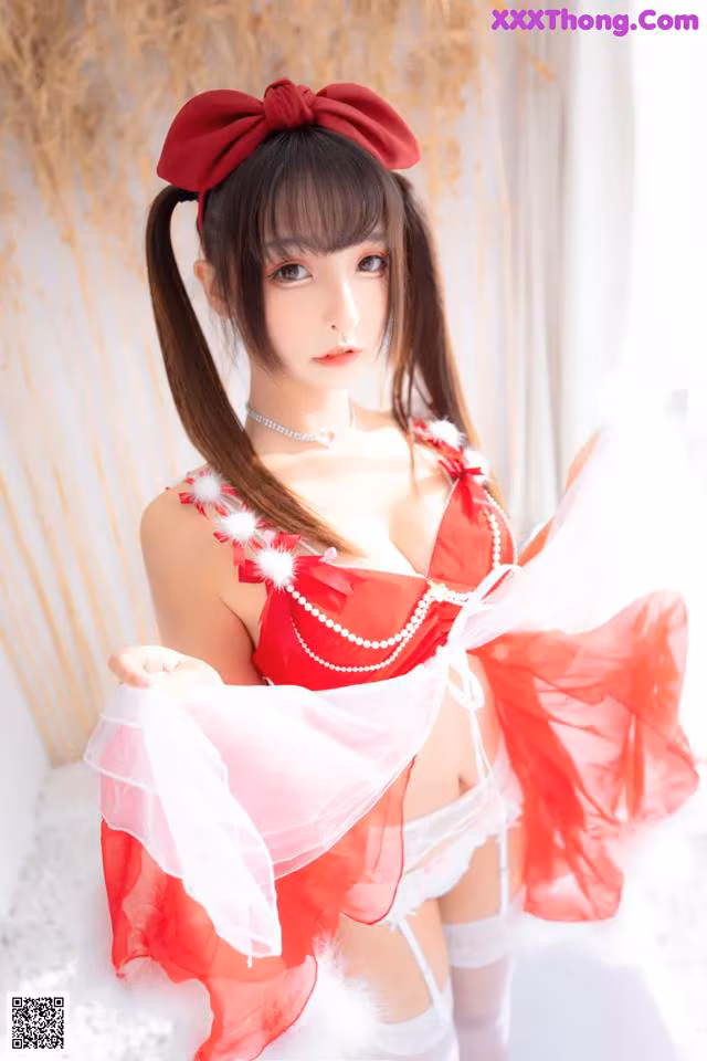 A woman in a red and white lingerie posing for a picture.