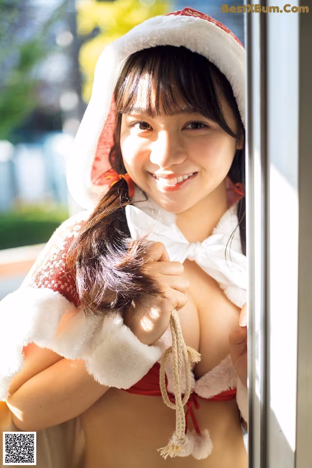 A woman in a red and white outfit is posing for a picture.