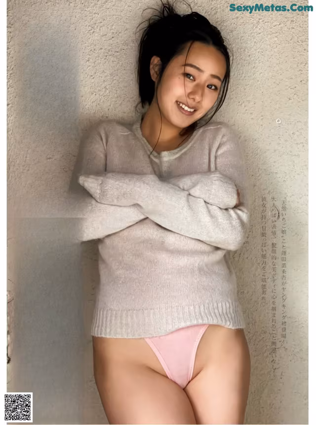 a woman in a white sweater and pink panties posing for a magazine